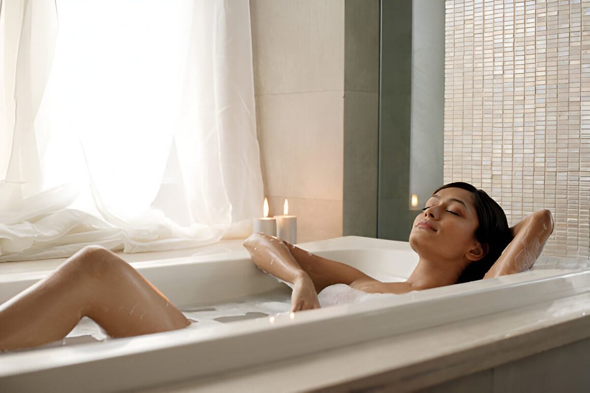 Blog post image with a a woman practicing self-care in a bathtub on winter self-care tips